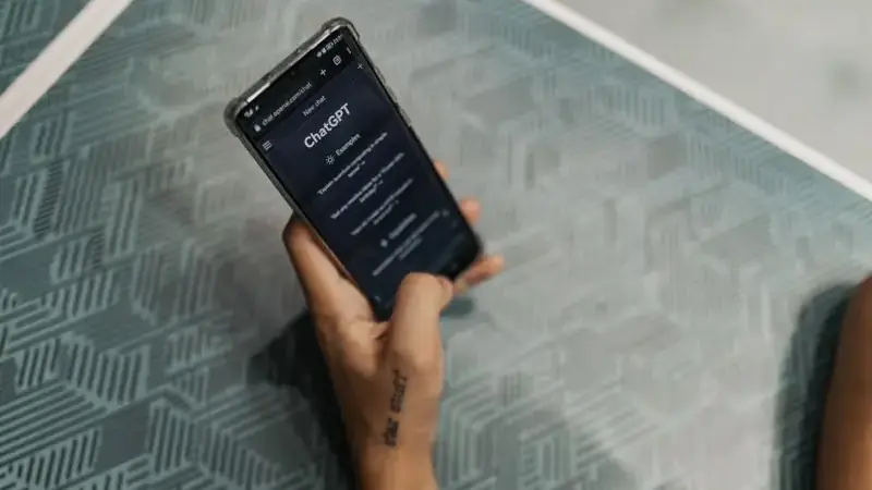 Hands holding a smartphone with a text chat conversation open